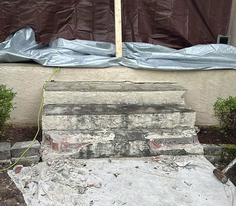 broken, destroyed brick and concrete steps leading up to house