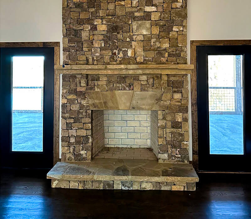 indoor floor to ceiling stone fireplace